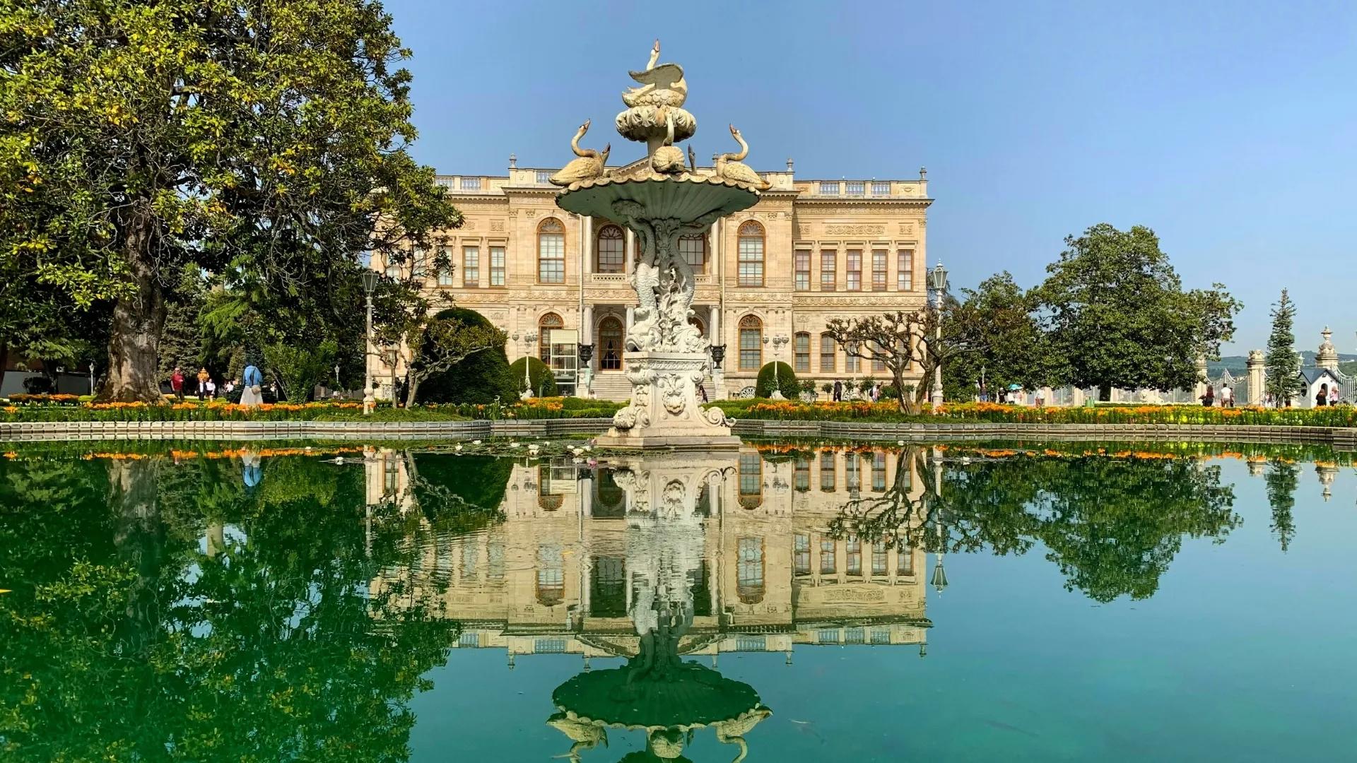 Walk through Dolmabahce Palace gardens on a historic Istanbul sightseeing tour with palace and fountain views.