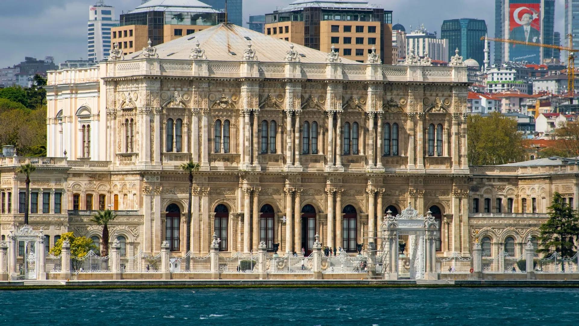 Admire the waterfront facade of Dolmabahce Palace during an Istanbul Bosphorus cruise and cultural tour.