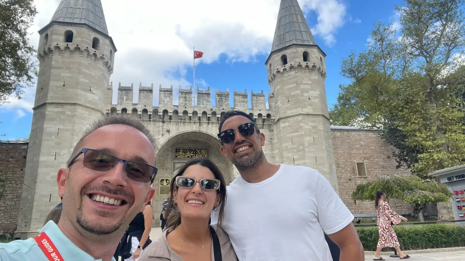 Guests posing at the historic entrance of Topkapi Palace with their private guide.