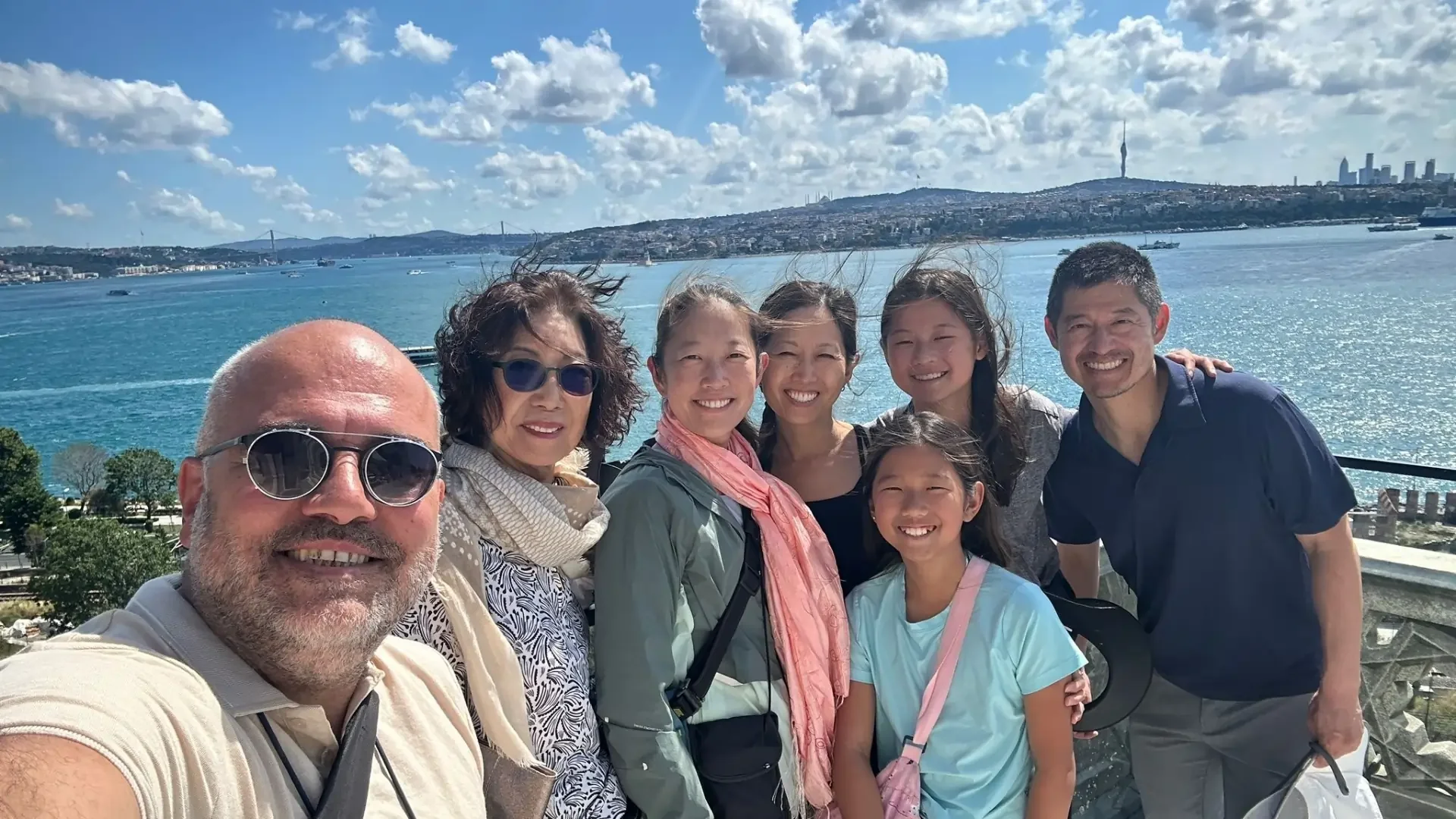 Family enjoying panoramic Bosphorus views from Topkapi Palace's terrace during a private Istanbul shore excursion.