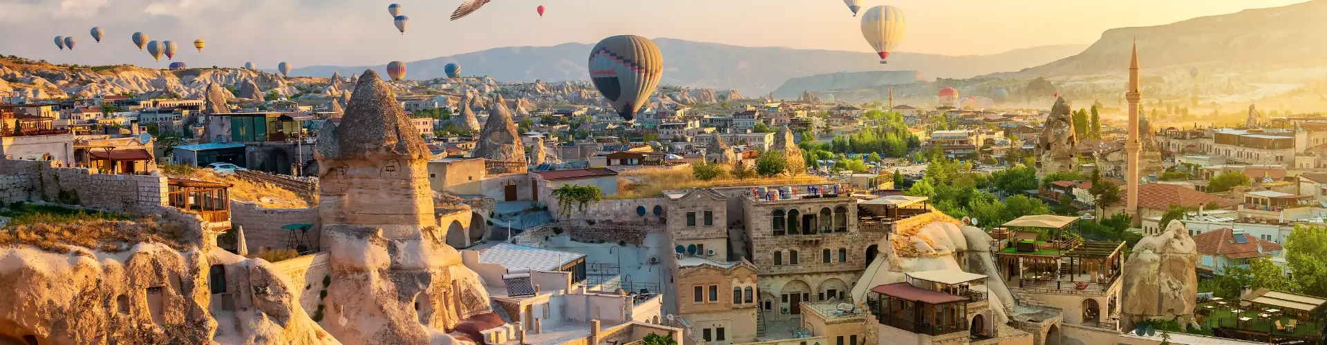 Hot air balloons flying over the unique fairy chimneys in Cappadocia