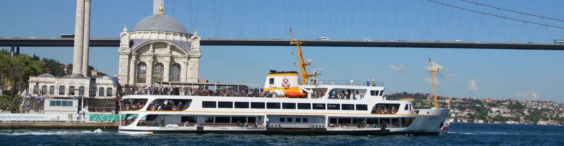 Ortakoy Mosque situated perfectly under the Bosphorus Bridge during a cruise.